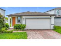 Charming single-story home with a two-car garage and well-maintained landscaping at 29783 Anahid Dr, Leesburg, FL 34748