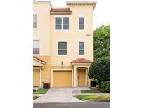 Charming two-story townhouse featuring a private garage and covered entrance at 8024 Cool Breeze Dr # 132, Orlando, FL 32819