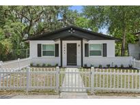 Charming home with a white picket fence, black trim, and beautiful curb appeal at 1002 Cypress Ave, Sanford, FL 32771