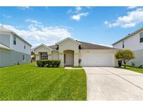 Charming one-story home with a well-manicured lawn and a two car garage, perfect for suburban living at 10828 Cherry Oak Cir, Orlando, FL 32817