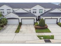 Charming townhome with a well-manicured lawn, private garages, and a neatly landscaped yard at 1275 Shallcross Ave, Orlando, FL 32828
