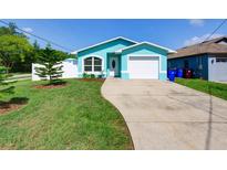 Charming, updated single-Gathering home with a well-manicured lawn, new landscaping, and an attached garage at 1618 Oregon Ave, St Cloud, FL 34769