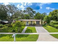 Charming single-story home boasts lush landscaping, a brick driveway, and inviting curb appeal at 1649 W Waycross Cir, Deltona, FL 32725
