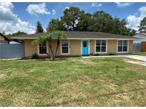 Charming single-story home featuring a bright blue front door and well-maintained lawn at 211 Valencia Rd, Debary, FL 32713