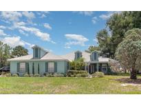 Charming single-story home with lush front yard and well-maintained landscaping at 2283 Knollwood Dr, Leesburg, FL 34748