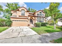 Two-story home with a two-car garage and a well-manicured front yard at 2971 Cayman Way, Orlando, FL 32812