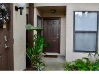 Inviting front door entrance with lush greenery and a welcoming mat at 3012 S Semoran Blvd # S, Orlando, FL 32822