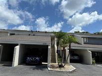 Charming condo featuring private covered parking, well-maintained landscaping, and convenient stair access at 5395 Vineland Rd # S, Orlando, FL 32811