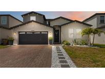 Beautiful home exterior with a brick driveway and manicured landscaping at 5639 Timber Meadow Way, St Cloud, FL 34771