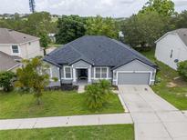 Well-maintained home with a two-car garage, lush lawn and tidy landscaping at 1780 Nature Cove Ln, Clermont, FL 34711