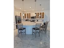 Modern kitchen featuring a large island, stainless steel appliances, and open shelving at 2496 Rama Dr, Kissimmee, FL 34746