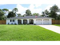 Charming single-story home with a well-manicured lawn and attached three-car garage at 300 Royal Palm Ct, Longwood, FL 32779