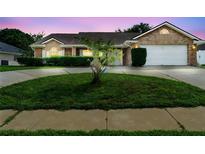 Charming one-story brick home with a manicured lawn and driveway at 40 Hollow Pine Dr, Debary, FL 32713