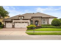 Beautiful single-story home with a three-car garage and well-maintained landscaping at 4221 Isle Vista Ave, Belle Isle, FL 32812