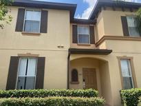 Inviting two-story home featuring charming architecture and well-manicured landscaping at 487 La Mirage St, Davenport, FL 33897