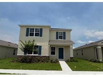Two-story home boasts well-manicured lawn and blue shutters at 5274 Scrub Mint Ln, Apopka, FL 32712