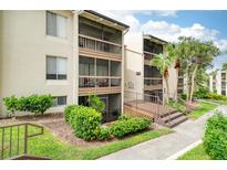 Inviting condo complex featuring private screened balconies and lush landscaping at 572 Orange Dr # 57, Altamonte Springs, FL 32701