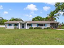 Charming single-story home with blue shutters and a well-manicured lawn at 5984 Ed Harris Ct, St Cloud, FL 34771