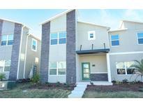 Modern two-story home with stone accents and well-maintained landscaping at 976 Leader St, Davenport, FL 33896