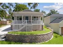 Charming single-story home featuring a welcoming front porch and well-maintained landscaping at 1031 Morningside Dr, Eustis, FL 32726