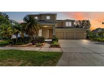 Inviting two-story home with a three-car garage and lush landscaping at 13519 Bicton Ln, Windermere, FL 34786