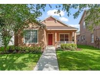 Charming home with a manicured lawn, mature trees, and a cozy front porch perfect for enjoying the outdoors at 13768 Bluebird Pond Rd, Windermere, FL 34786