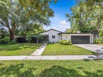 Charming single story home with freshly painted exterior, mature trees and well maintained lawn at 2244 Brookshire Ave, Winter Park, FL 32792