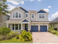 Charming two-story home with a brick paver driveway and manicured landscaping in a beautiful neighborhood at 5161 Dove Tree St, Orlando, FL 32811
