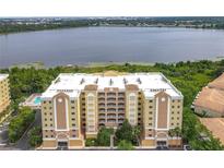 Beautiful condo with balconies and stunning lake views, complemented by lush landscaping at 6336 Buford St # 207, Orlando, FL 32835