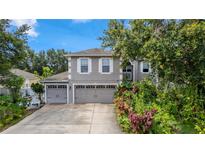 Charming two-story home featuring a well-manicured front yard and an attached two-car garage at 7642 Park Hill Ave, Leesburg, FL 34748