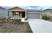 Charming single-story home with a two-car garage and newly installed landscaping at 1147 Pomelo St, Davenport, FL 33837