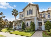 Charming two-story home featuring a well-manicured lawn, inviting front porch, and attractive architectural details at 13755 Benavente Ave, Orlando, FL 32827