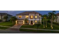 Stunning two-story home with a paved driveway and lush landscaping at 1551 Gateway Ln, Kissimmee, FL 34746