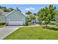 Charming home featuring a well-manicured lawn and beautiful landscaping at 195 River Village Drive, Debary, FL 32713