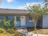 Charming home exterior featuring a light blue door and well-maintained landscaping at 249 Spartan Dr, Maitland, FL 32751