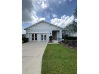 Charming single-story home with a well-manicured lawn and a double-door entry, located on a sunny street at 2519 Avalon Park Blvd, Tavares, FL 32778