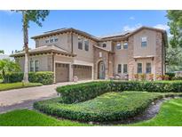 Stunning two-story home with well-manicured landscaping and three-car garage at 25537 High Hampton Cir, Sorrento, FL 32776