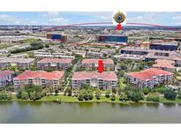Stunning aerial view of a multi-Gathering dwelling near a lake and Epic Universe in Orlando, Florida at 5024 Shoreway Loop # 10106, Orlando, FL 32819