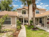 Inviting condo features a charming exterior with mature trees and a covered entryway at 546 Northbridge Dr, Altamonte Springs, FL 32714