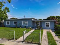 Charming single-story home with well-maintained lawn, freshly painted exterior, and freshly cemented driveway at 7033 Lakner Way, Orlando, FL 32822
