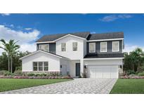Modern two-story home featuring a two-car garage, paver driveway, and beautiful landscaping at 1508 Stonecliff Dr, Apopka, FL 32703