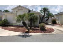 Charming single-story home featuring well-maintained landscaping with palm trees and neutral exterior paint at 1524 Conway Ct, The Villages, FL 32162