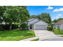 Charming single-story home featuring lush landscaping, a well-maintained lawn, and a two-car garage at 222 Imperial Ridge Ct, Oviedo, FL 32765