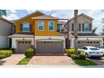 Two-story townhouse featuring an attached garage and well-maintained landscaping at 3508 Brighton Park Cir, Belle Isle, FL 32812