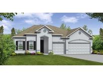 Charming single-story home with a well-maintained lawn and a two-car garage at 351 S Sunset Ave, Mascotte, FL 34753