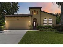 Charming home featuring a well-manicured lawn, two-car garage, and a unique architectural design at 3637 Foxchase Dr, Clermont, FL 34711