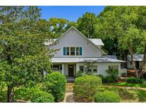 Charming two-story home featuring a landscaped yard, inviting porch, and traditional architectural details at 408 W Pearl St, Minneola, FL 34715