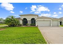Charming home featuring a well-manicured lawn, three-car garage and lovely landscaping at 742 Seneca Trl, St Cloud, FL 34772
