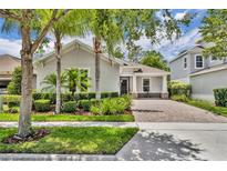 Charming single-story home with a well-manicured lawn and inviting curb appeal and paver driveway at 7834 Minutemen Loop, Winter Garden, FL 34787