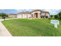 Well-maintained home with lush green lawn and charming curb appeal at 8865 Se 119Th St, Summerfield, FL 34491